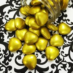 gold foiled chocolate hearts spilling out of a jar