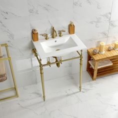 a white sink sitting next to a wooden table and chair in a room with marble walls