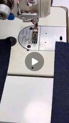 someone is using a sewing machine to sew on some blue jeans with the help of an applique