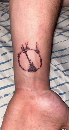 a person with a tattoo on their foot that has an arrow in the middle of it