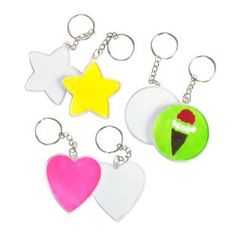 four key chains with different designs and colors on them, one has an ice cream cone, the other has a star