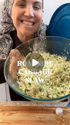 a woman holding a bowl full of cabbage slaw