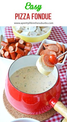 a red pot filled with pizza fondue on top of a table