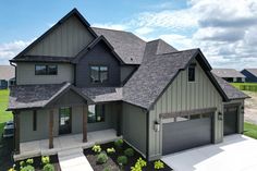 this is an artist's rendering of a house in the country side with two garages