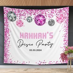 a pink and white wall hanging on the side of a building with disco ball decorations