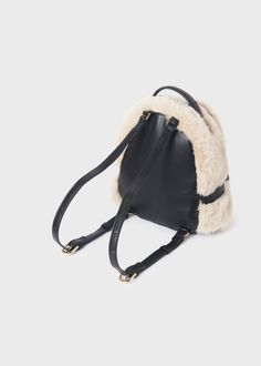 This Abel & Lula Faux Fur Backpack for girls features a stylish outside made of 70% polyester and 30% polyurethane and a cozy 100% polyester lining. Perfect for everyday wear, this backpack adds a touch of luxury to any outfit. Winter Travel Bag With Adjustable Strap, Winter Backpack For Daily Use, School Backpack With Adjustable Strap For Fall, Fall School Backpack With Adjustable Strap, Trendy Travel Backpack For Winter, Fall Backpack With Adjustable Strap, Trendy Winter Travel Backpack, School Backpack With Zipper Closure For Fall, Winter School Backpack