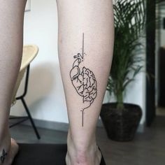 a person with a tattoo on their leg that has a drawing of a human brain