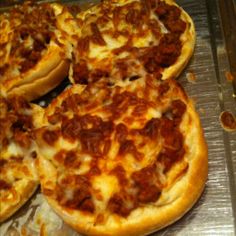 several pizzas sitting on top of a metal tray