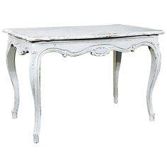 a white table with an ornate design on the top and legs, against a white background