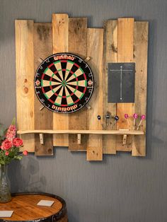 a dart board mounted to the side of a wooden wall rack with darts on it