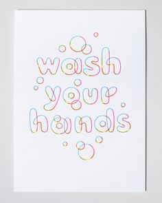 the words wash your hands are written in multicolored letters on white paper with black ink