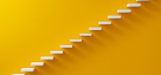 white steps going up to the top of a yellow wall with an orange back ground