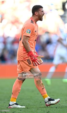 a soccer player with his mouth open on the field