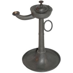 an old fashioned metal candle holder on a white background