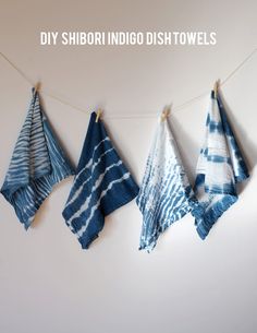 three towels hanging on a clothes line with the words diy shibori indigoo dish towels