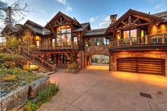 a large house with lots of windows and stone