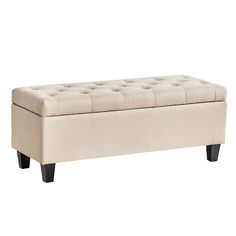 a beige bench with black legs and buttons