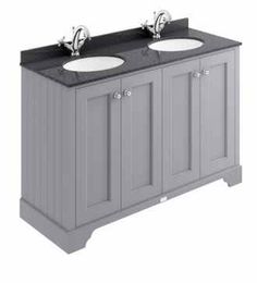 a double sink vanity with granite top and two faucets on the sides, in grey