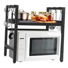 a microwave oven sitting on top of a rack filled with cooking utensils and food