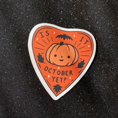 an orange and black sticker that says it's october yet