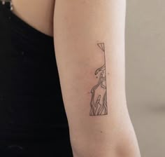 a woman's arm with a small tattoo on the left side of her body