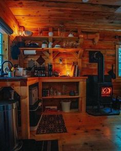 a kitchen with wood stove and wooden shelves