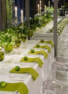 a long table is set with limes and place settings for an elegant dinner party