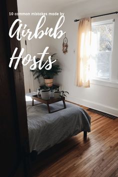 a bed sitting on top of a wooden floor in a bedroom next to a window