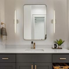 a bathroom vanity with two sinks and a large mirror over the sink in front of it