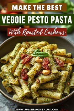 pesto pasta with roasted cashews in a bowl on top of a table