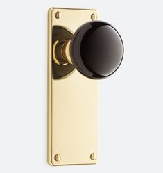 the door knob is black and gold with a round ball on it's side