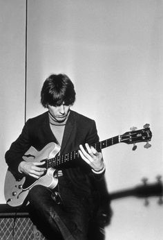 black and white photograph of a man playing an electric guitar