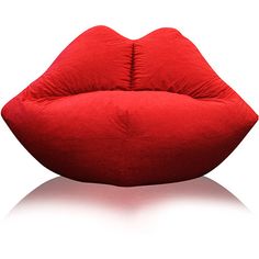 a large red pillow sitting on top of a white floor