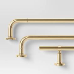 two gold faucets are shown against a white background and one is in the shape of a rectangle