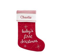 a red christmas stocking with the words baby's first christmas written on it