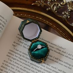 an open book with a ring in it