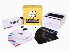 an assortment of business cards and pens in a box with the contents labelled, including