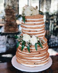 a three tiered cake with flowers on the top is displayed in an instagram