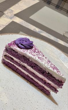 a piece of cake with purple frosting on a plate