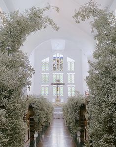 the inside of a church with white flowers