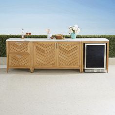 a tv sitting on top of a wooden cabinet