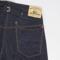 Roughly translated, ‘nonpareil’ means without equal or unmatched, and it is easy to see why it applies to these jeans. Brown-Duck & Digger have launched a jean with all charming characteristics of denim’s earliest years, a vintage inspired masterpiece which will take you back in time. This straight leg, mid rise jean is packed with features such as a one-pice button fly construction, side sewn selvedge line, cinch back, over seam riveted back pockets and watch pocket, and custom made cotton bran Jeans Back Pocket Design, Americana Fashion Men, Jeans Back Pocket, Selvage Denim Jeans, Boho Men Style, Orange Jeans, Selvage Denim, Workwear Vintage, Watch Pocket