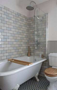 a white bath tub sitting next to a toilet