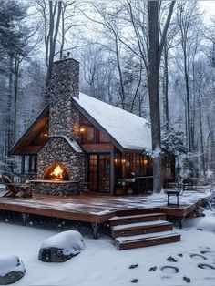 a cabin in the woods with snow on the ground and steps leading up to it