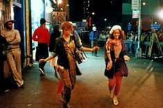 two women walking down the street at night