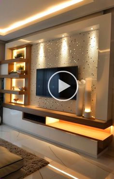 a living room with an entertainment center and built - in shelving unit, lighted by recessed lighting