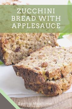 zucchini bread with applesauce is cut in half on a cutting board