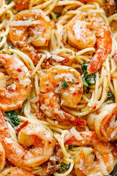 pasta with shrimp, spinach and parmesan cheese in a skillet ready to be eaten