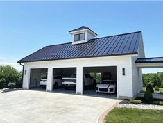 two cars are parked in the garage with their doors open and one car is on the other side