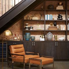 a chair and ottoman in front of a book shelf with books on it's shelves